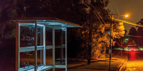 photograph of an empty bus stop late at night